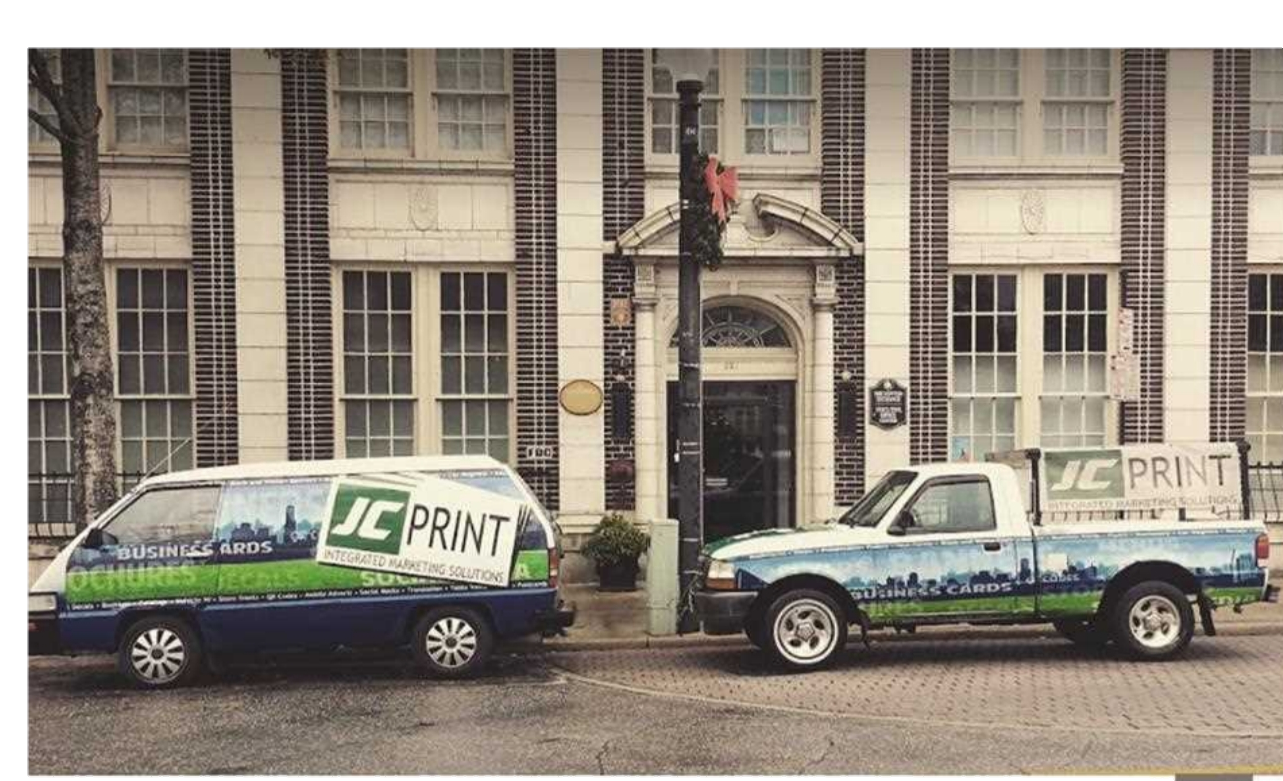 JC Print fleet in front of historic downtown building